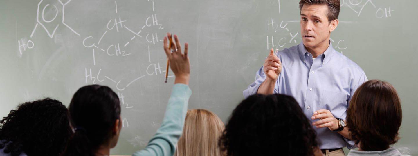 Kids raising hands in chemistry class