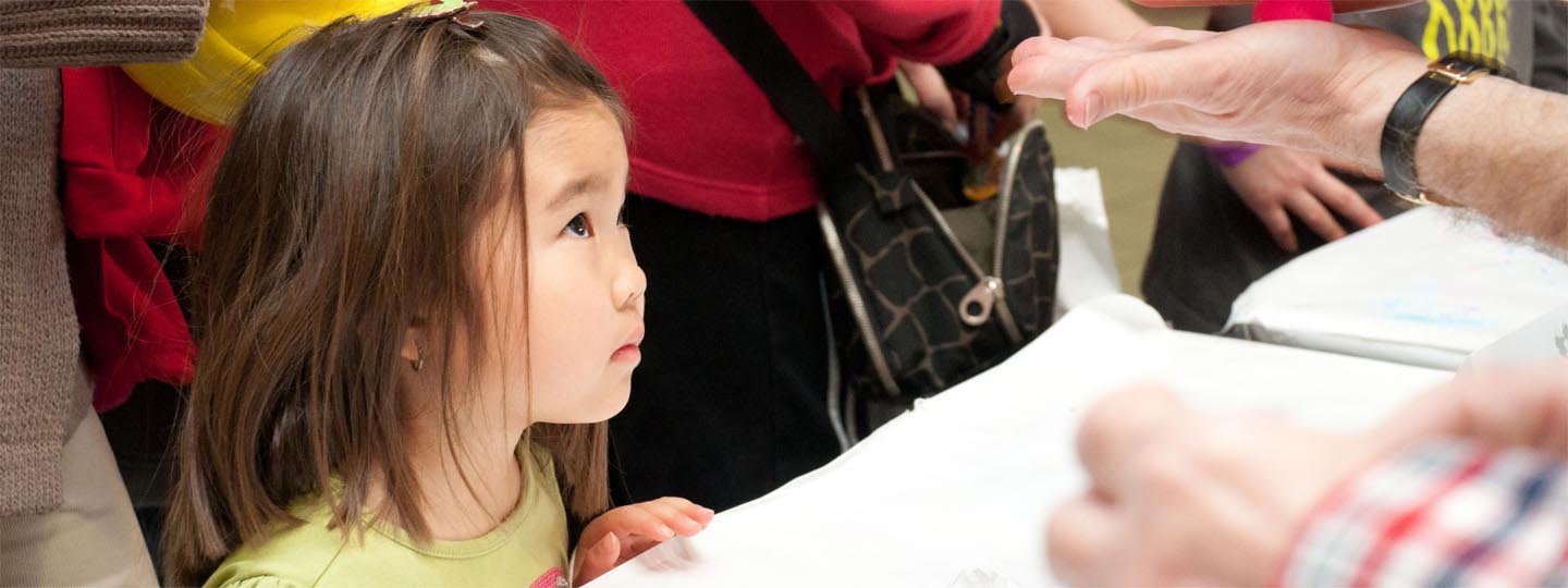 Little girl looking up a adult