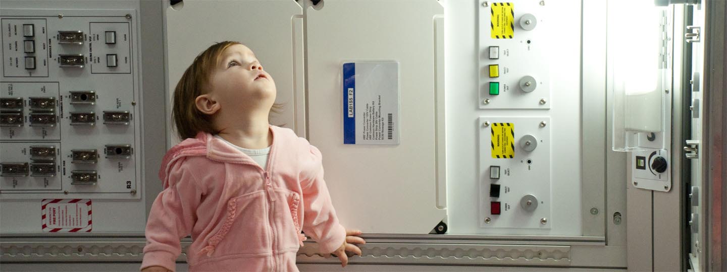 Little girl looking up in Space Station