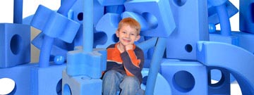 Child sitting with BLUE! blocks