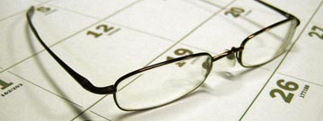 Eyeglasses sitting on a calendar