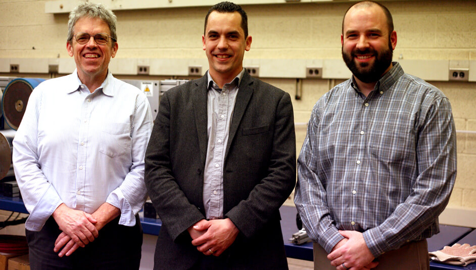 Three gentlemen standing with hands folded.