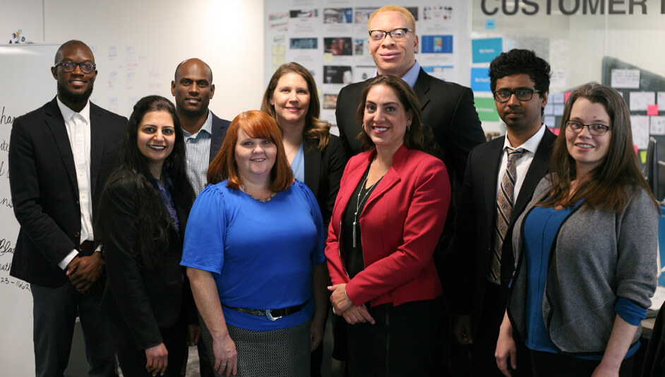 A group of men and women in business attire.