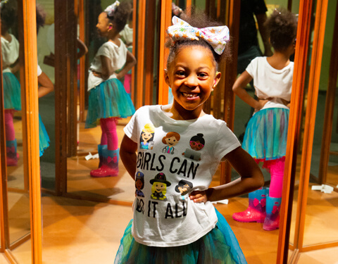 Girl posing in mirror room.