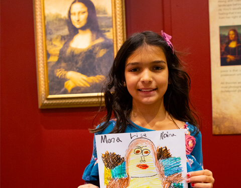 Girl holding a Mona LIsa that she drew.