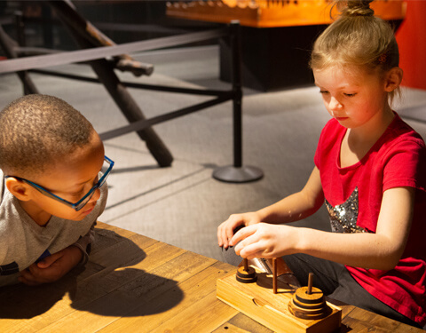 Boy and girl playing with stacking discs.