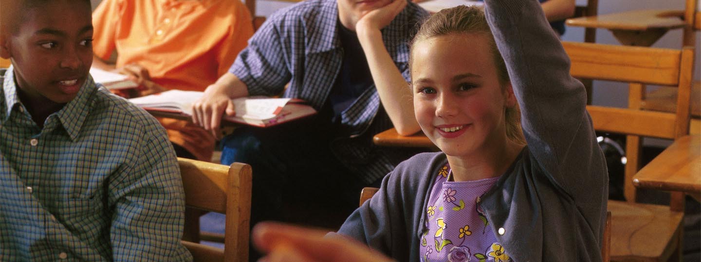 Girl raising her hand in class