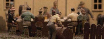 Close-up of group of miniature figures sitting at a table