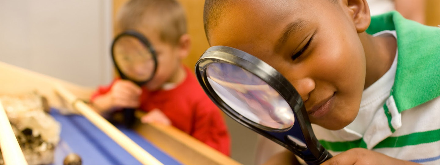 Kids looking through magnifying glasses