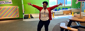 Science Center staff member smiling in the Little Learners Clubhouse